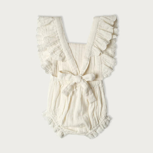 White ruffled organic cotton romper on a white background
