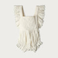 Load image into Gallery viewer, White baby romper with ruffled details on a white background
